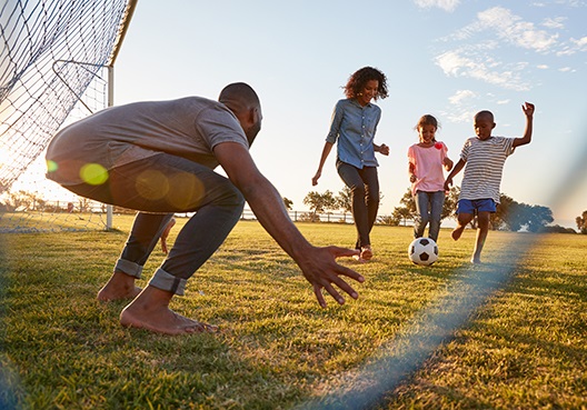 Family playing soccer